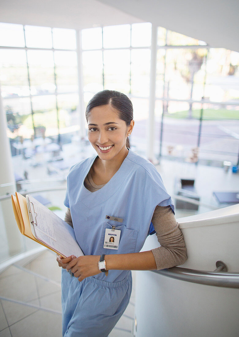 Smiling nurse on hospital staircase