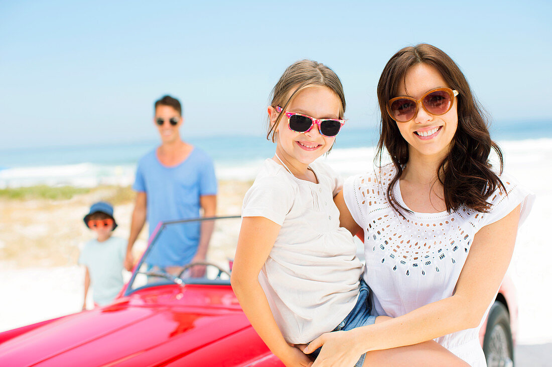 Mother and daughter smiling on beach