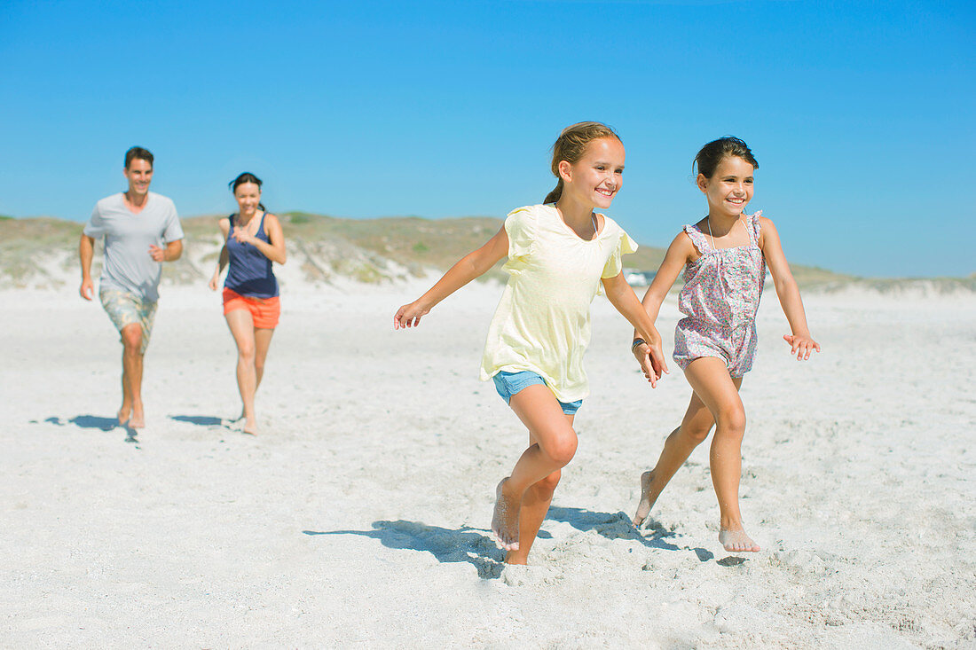 Family running together on beach