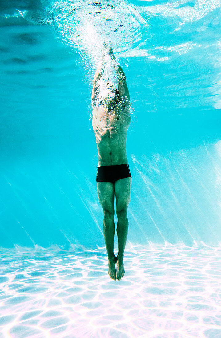 Man underwater in swimming pool