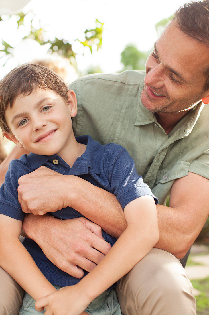 Father and son hugging outdoors