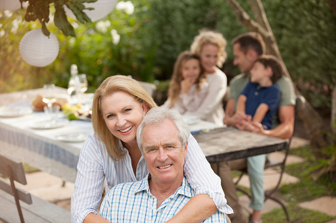 Smiling senior couple at family picnic