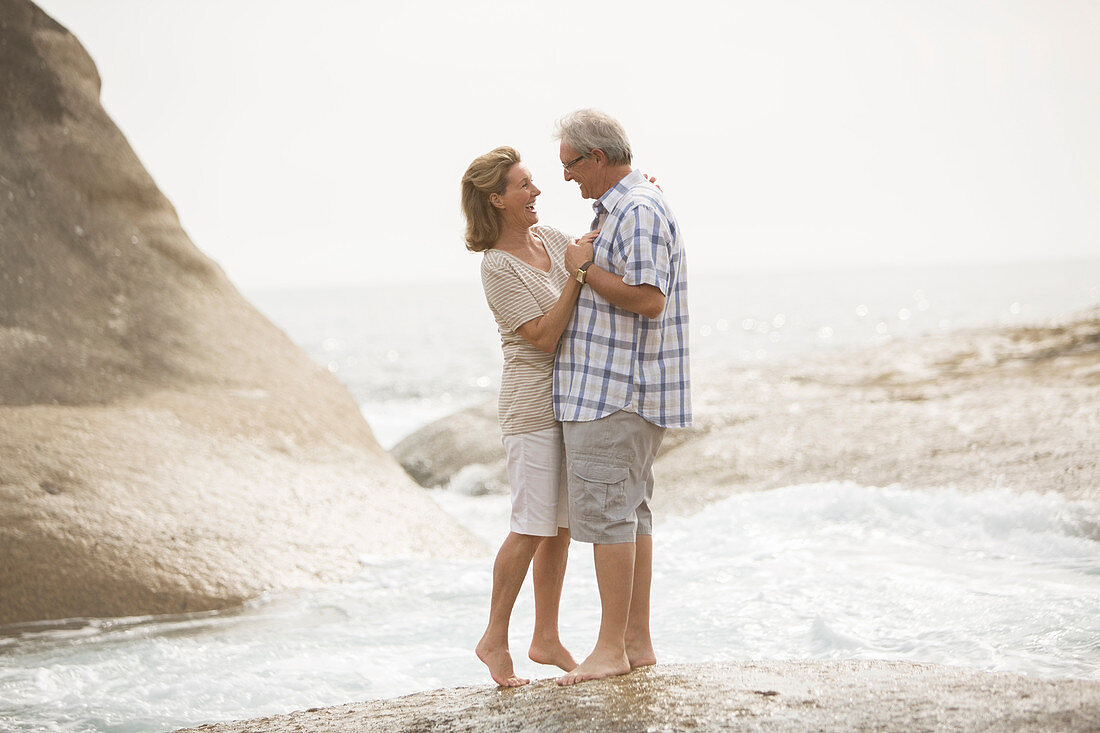 Senior couple hugging on beach