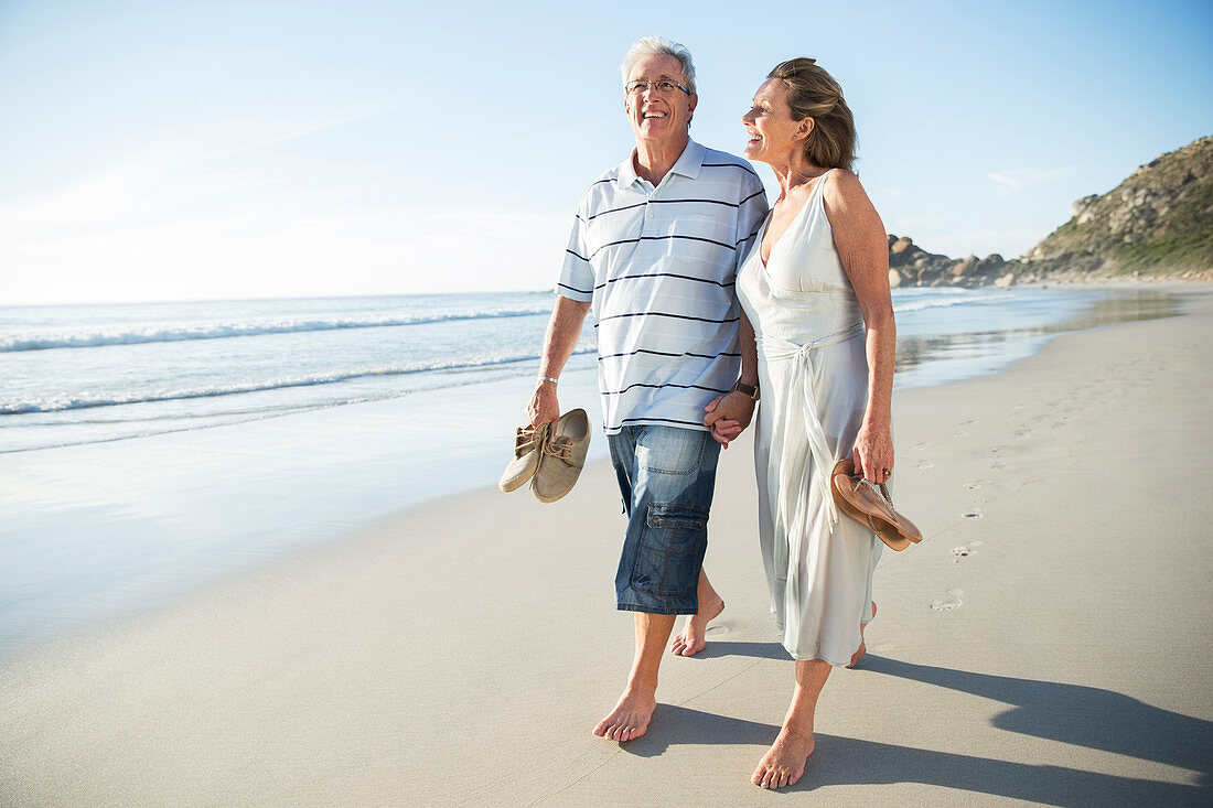 Senior couple walking on beach