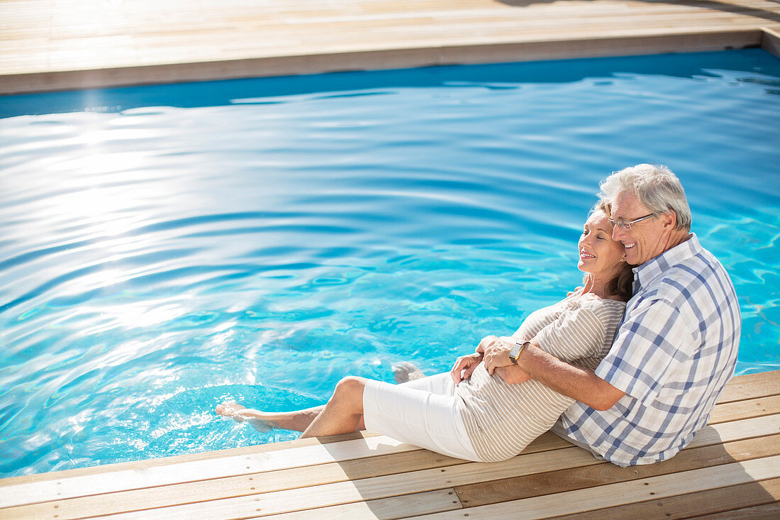 Senior couple relaxing by pool