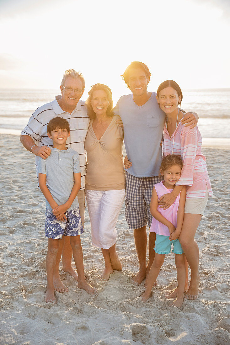 Family smiling together on beach