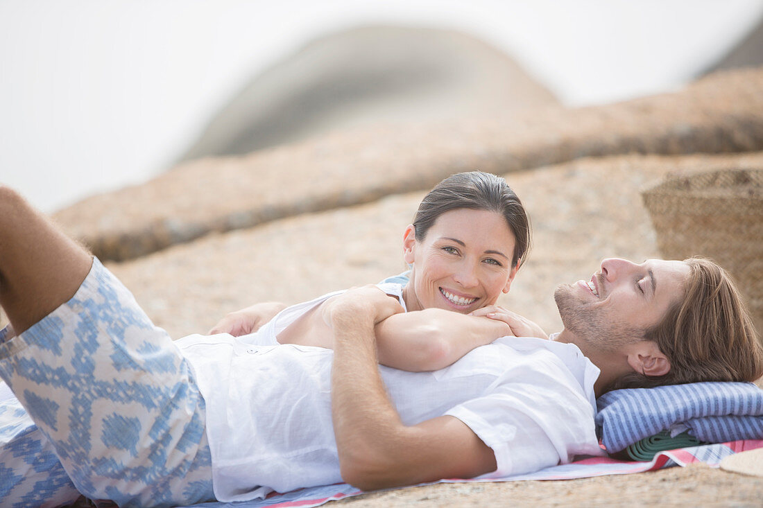 Couple relaxing on beach together