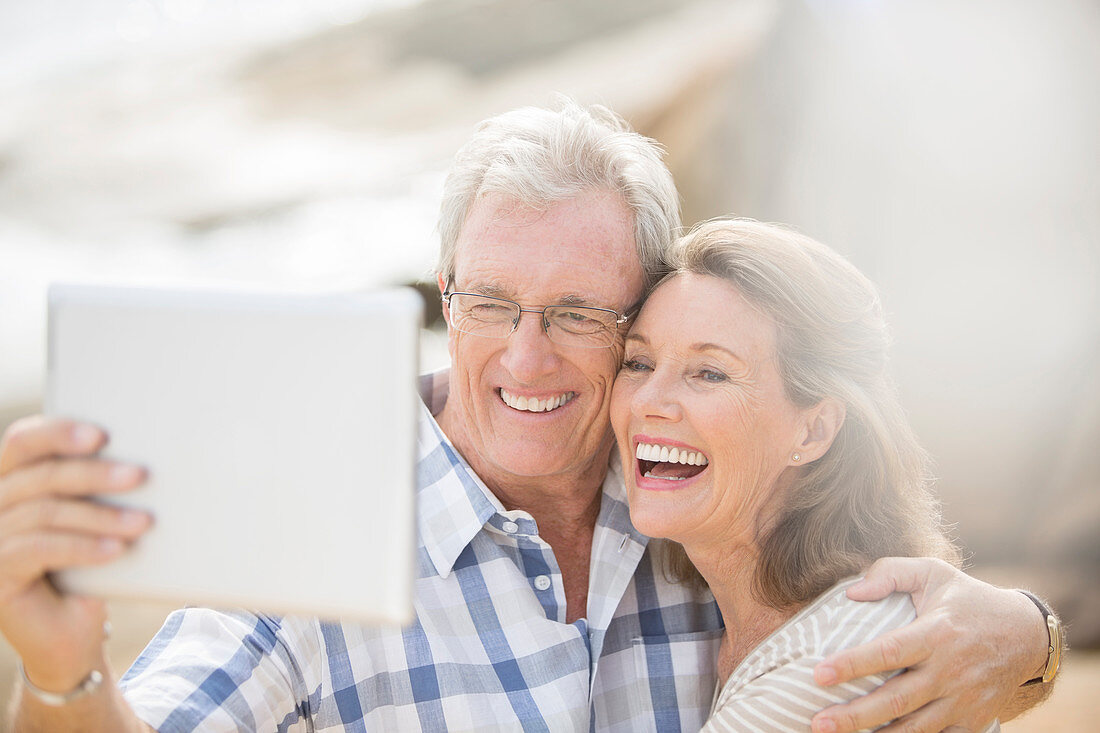 Older couple taking pictures with tablet