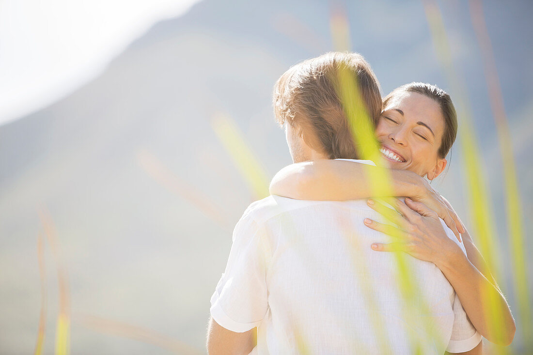 Couple hugging outdoors