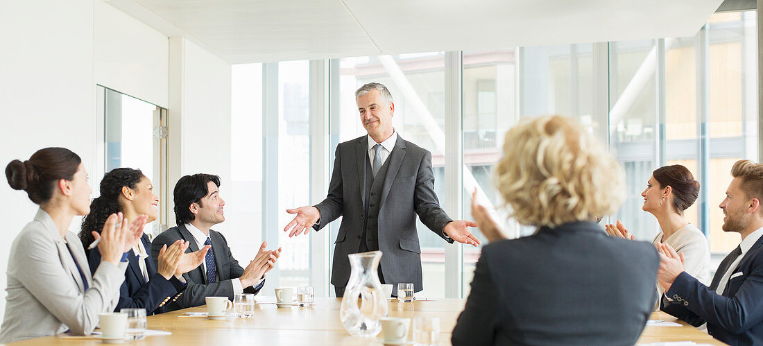 Business people clapping in meeting