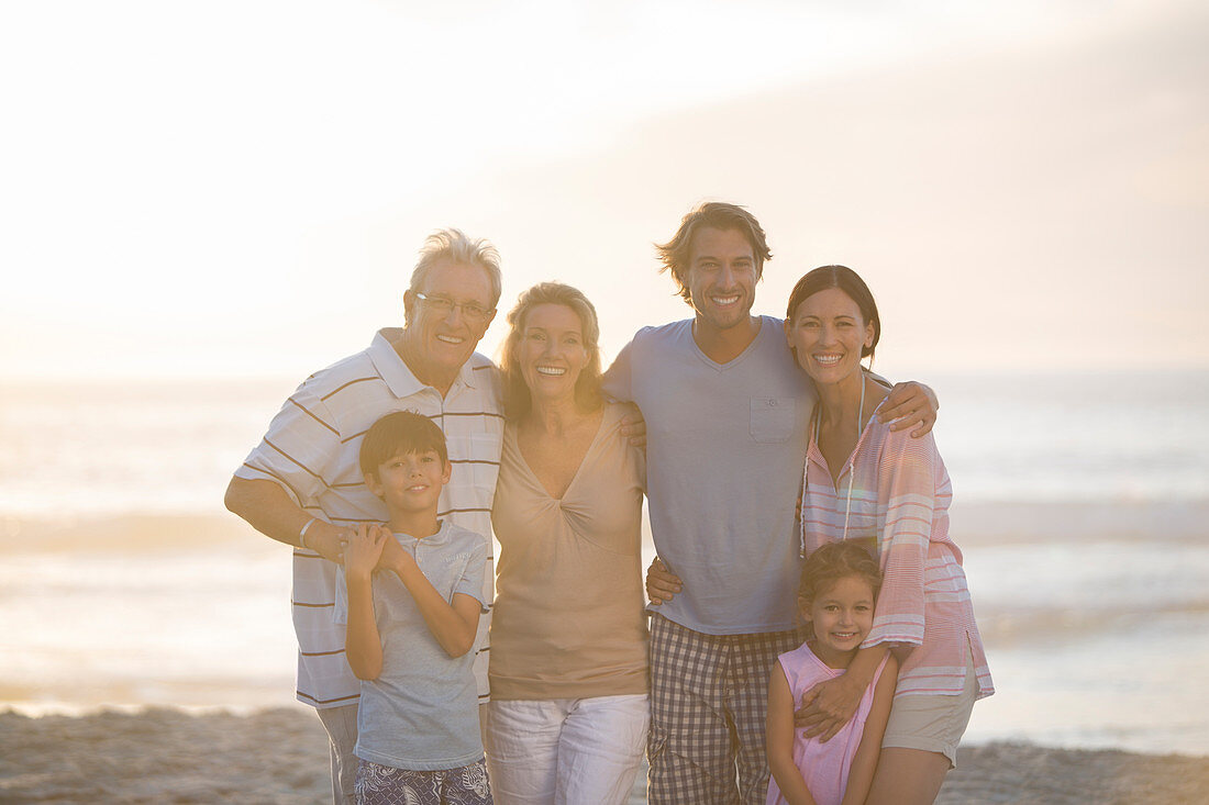 Family smiling together on beach