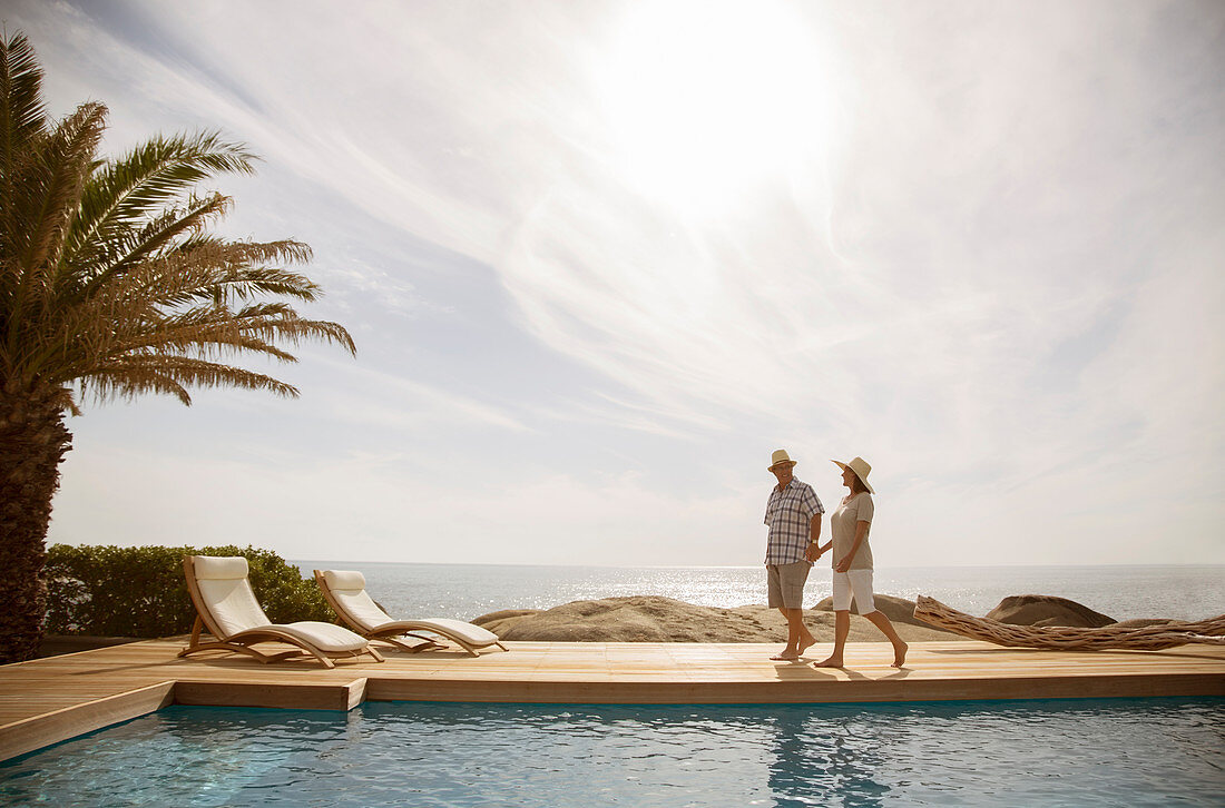 Older couple relaxing together by pool