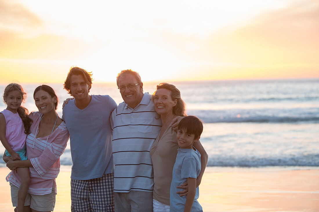 Family smiling together on beach