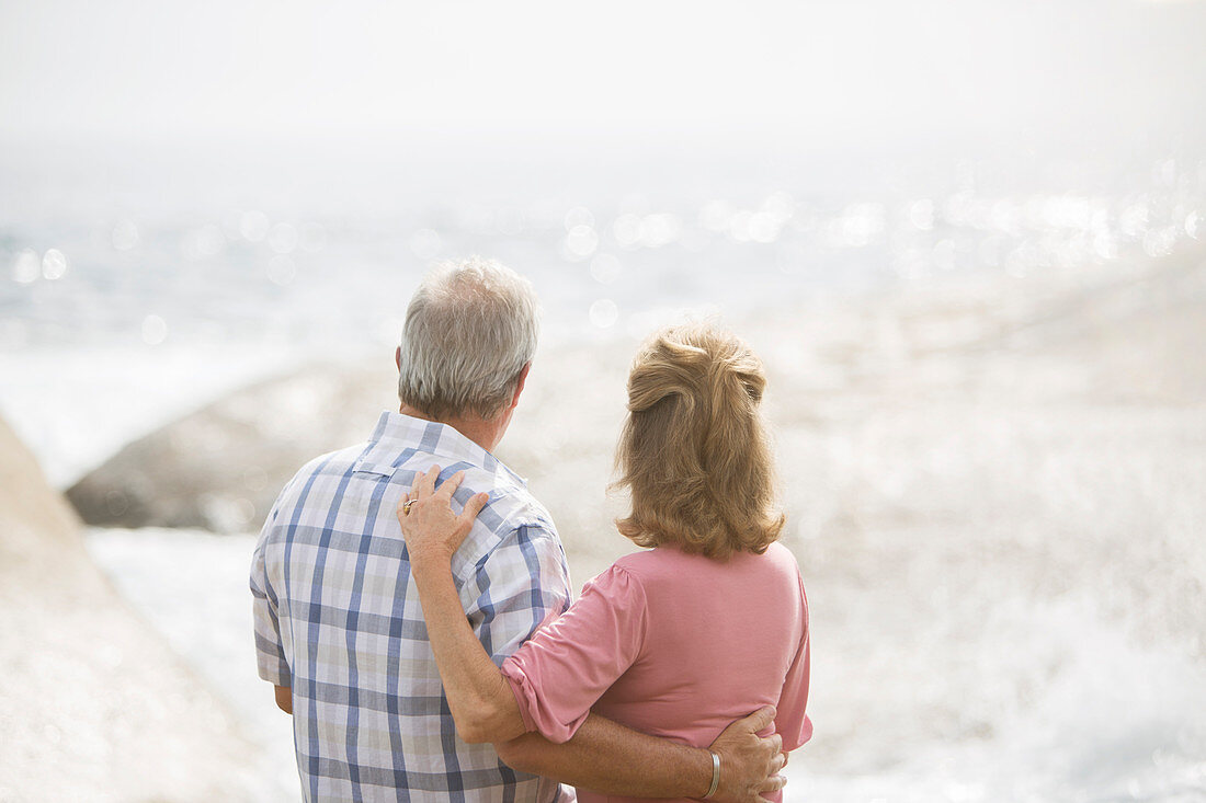 Older couple hugging on beach