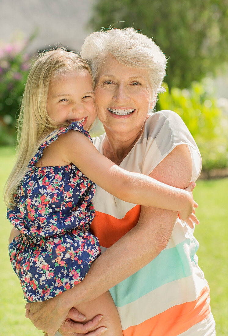 Older woman holding granddaughter