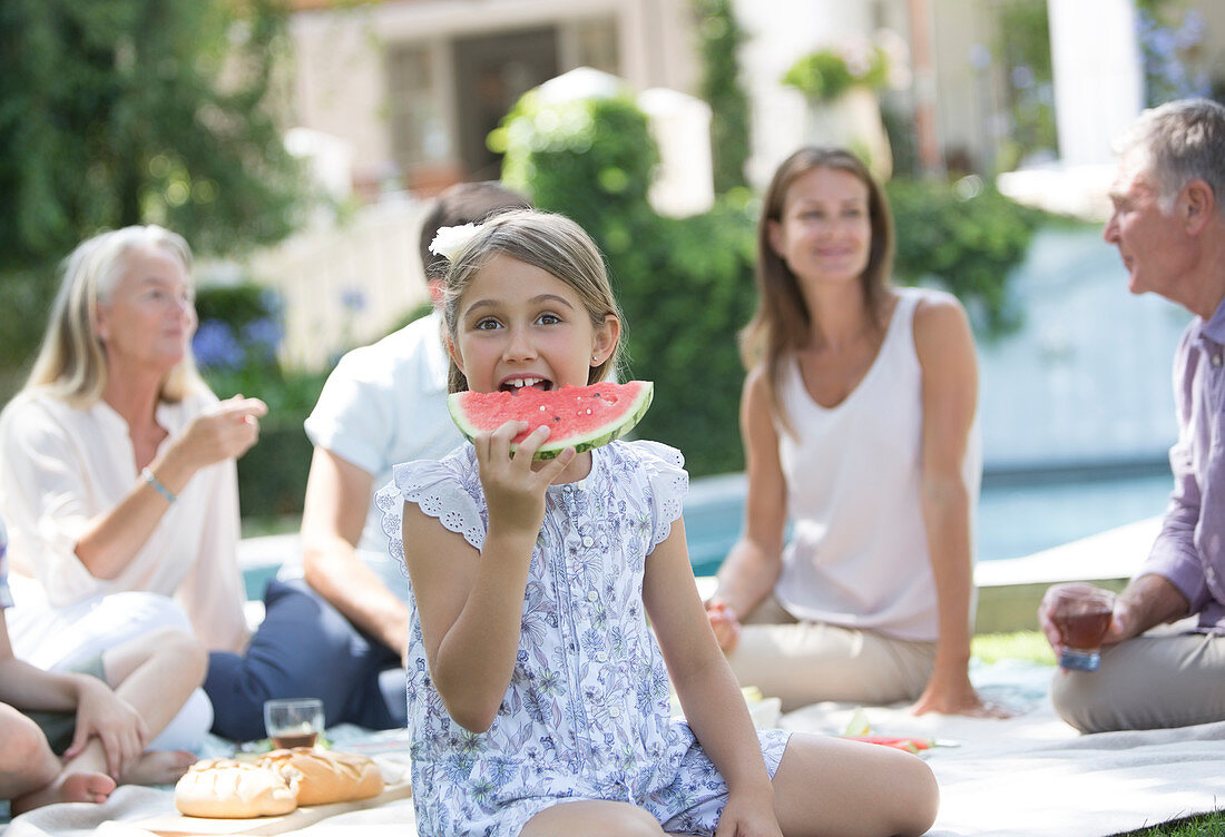 Girl eating watermelon at picnic