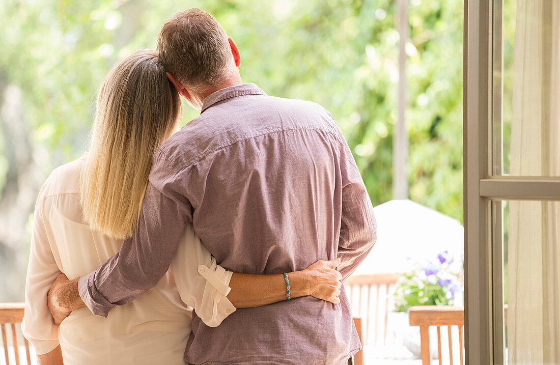 Senior couple hugging in doorway