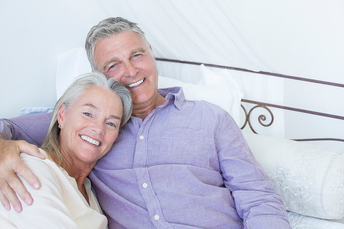 Senior couple laying on bed