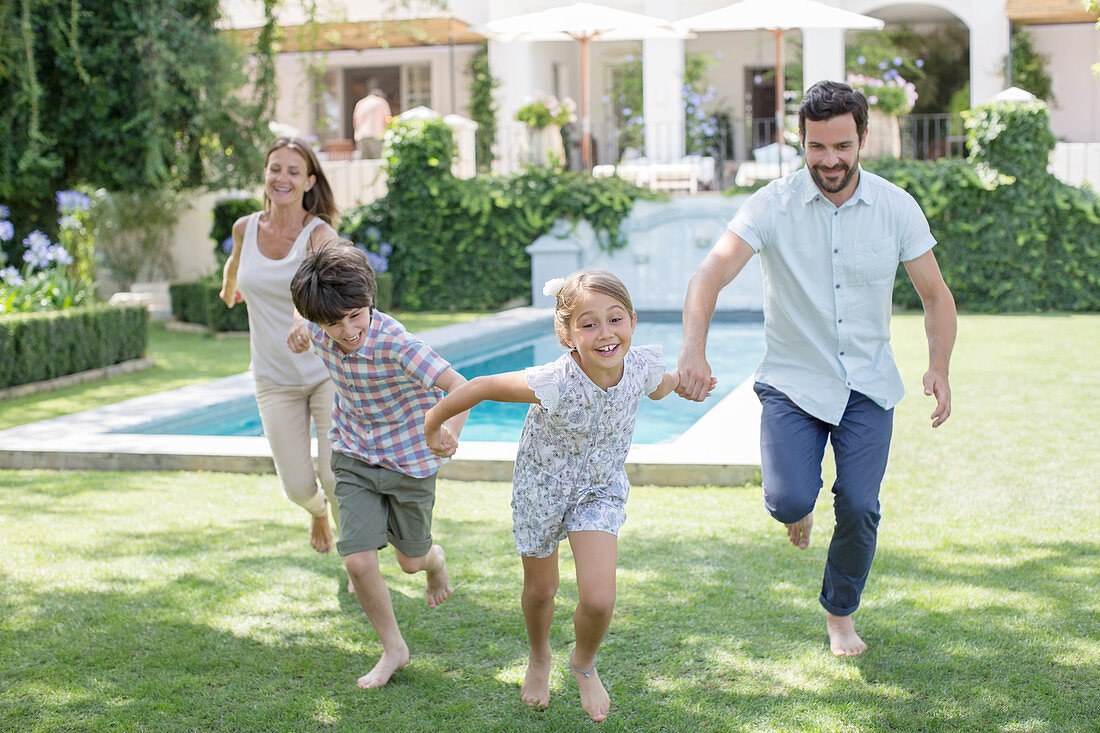 Family running together in backyard