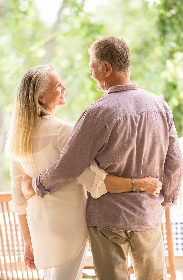 Senior couple hugging on patio