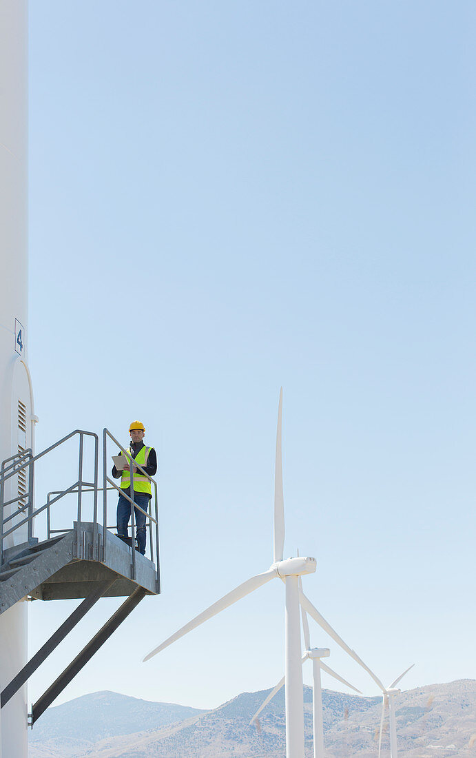Worker standing on wind turbine