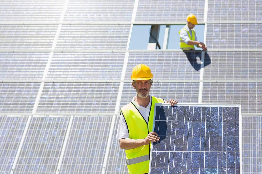 Worker holding solar panel