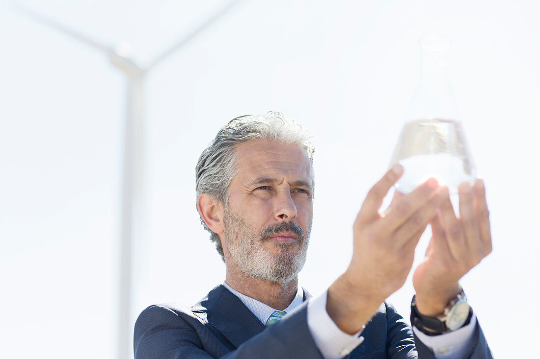 Businessman holding glass of water