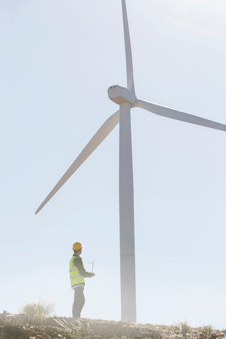 Businessman examining wind turbine