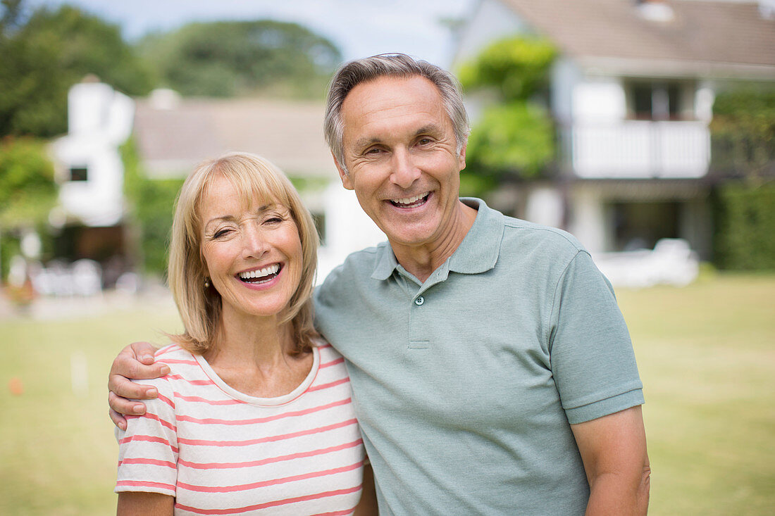 Smiling senior couple hugging outdoors