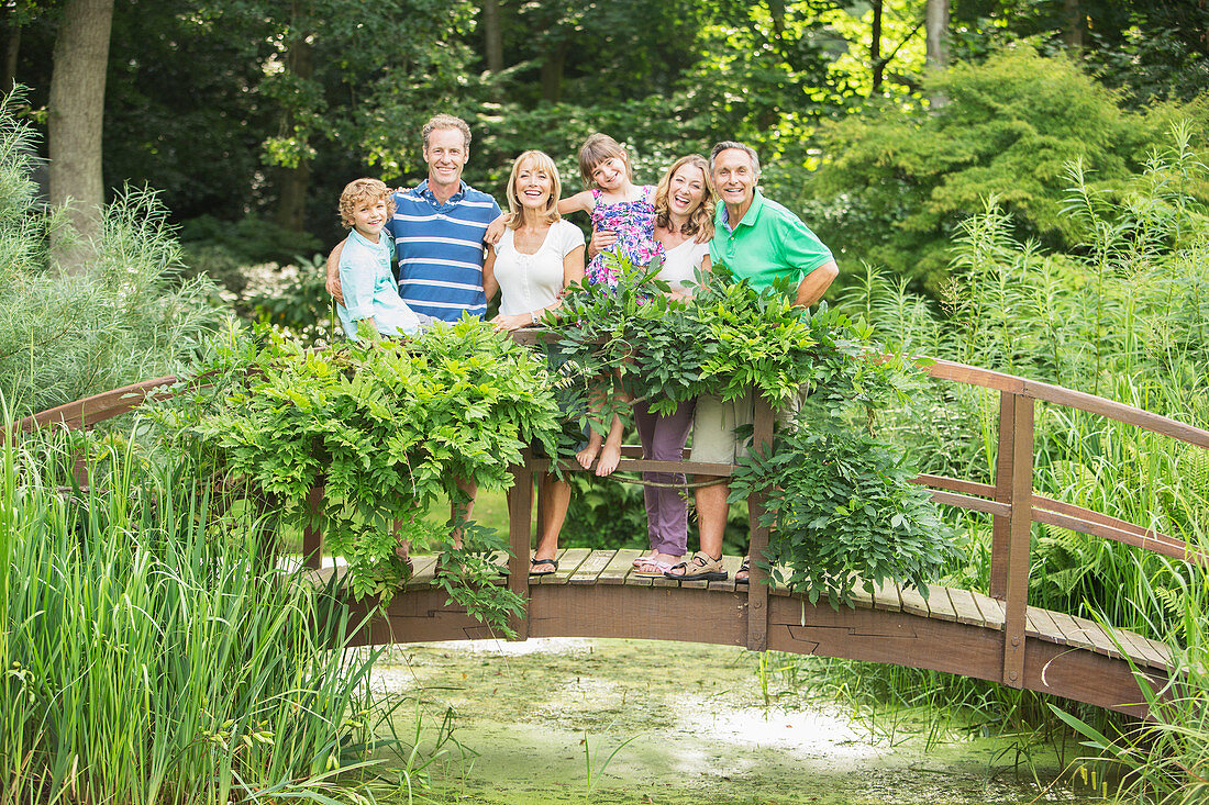 Family standing on wooden footbridge