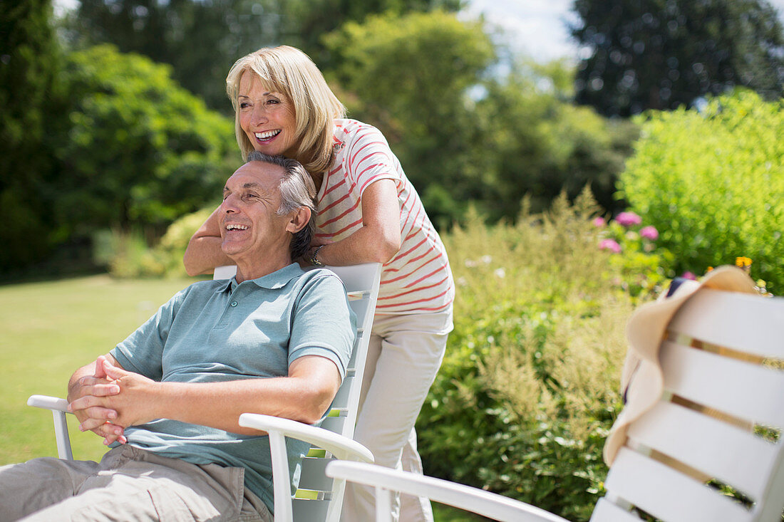 Senior couple relaxing in backyard