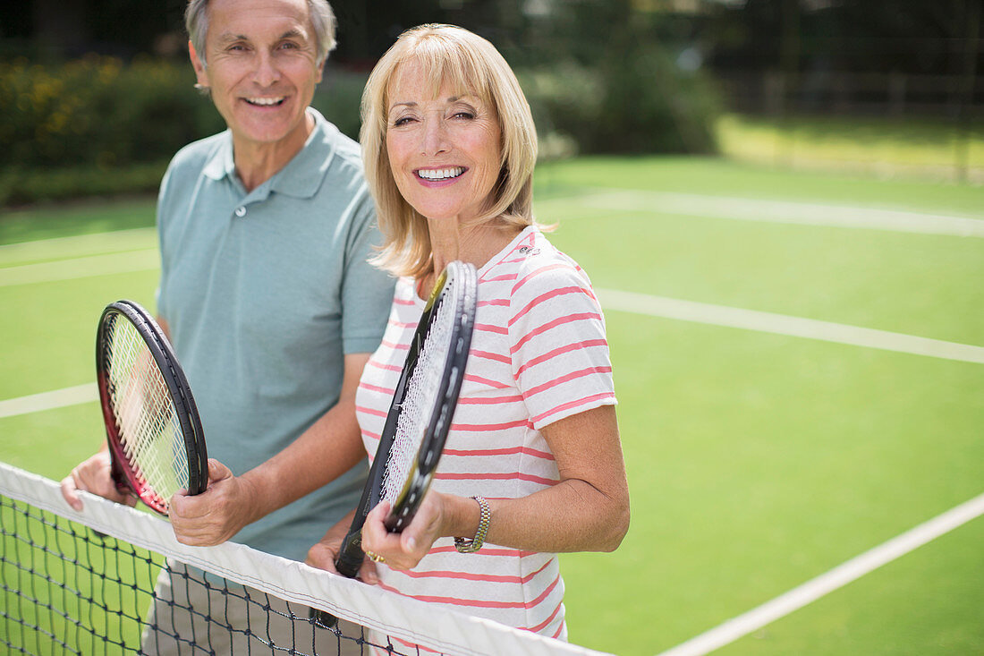 Couple smiling on tennis court