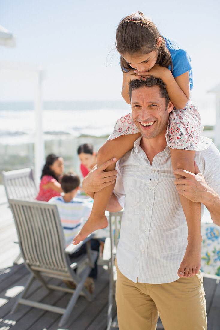 Father carrying daughter on shoulders