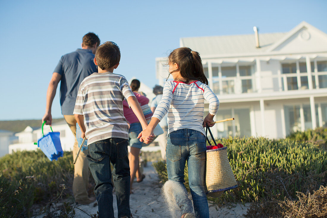 Brother and sister holding hands path