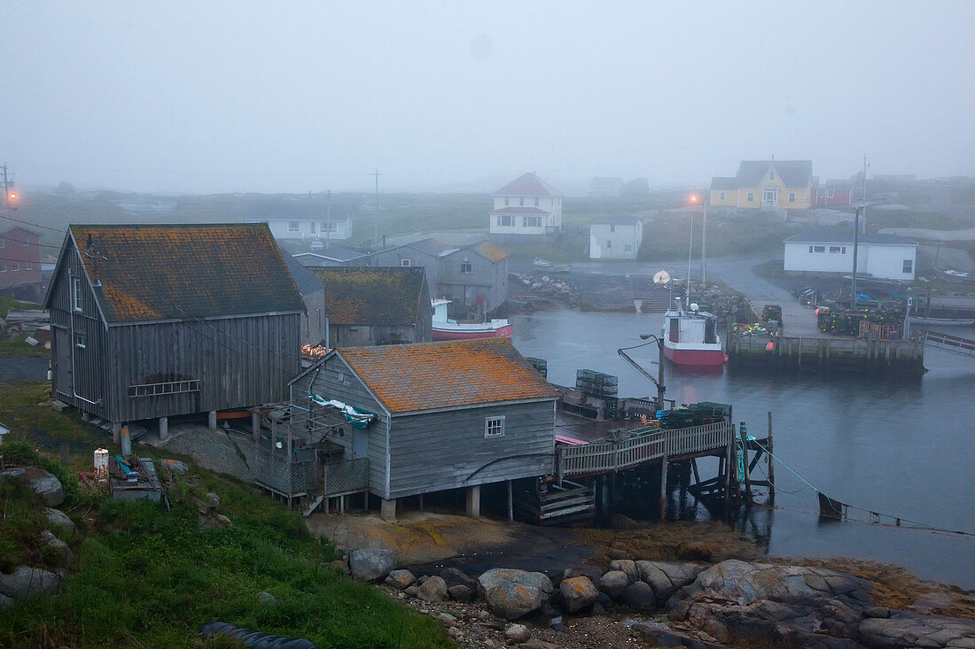 Fog surrounding buildings on bay