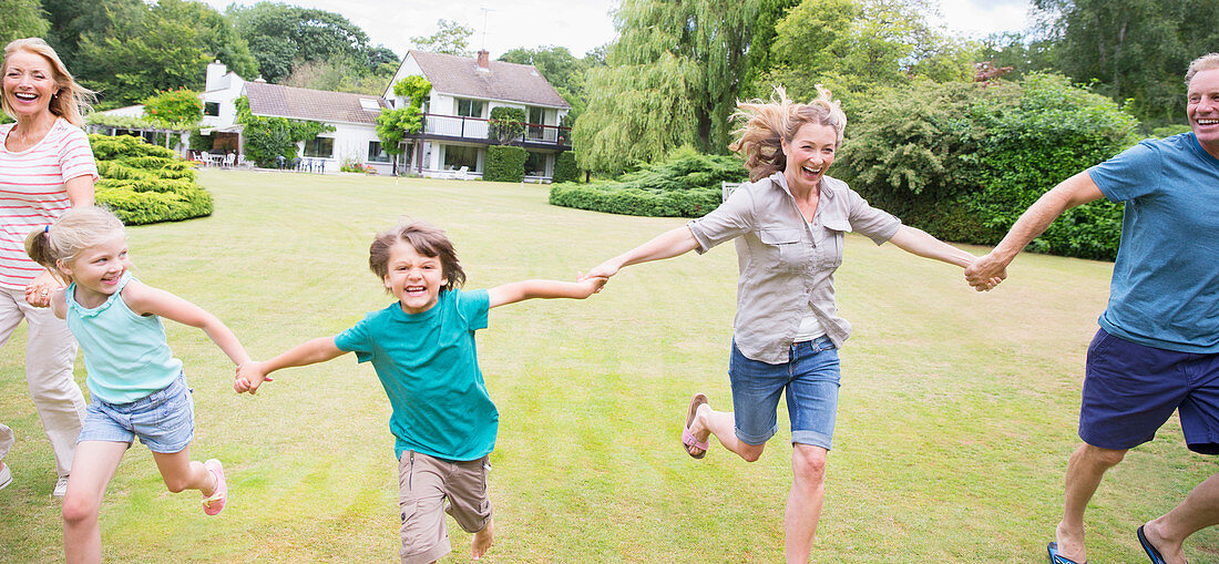 Family holding hands and running