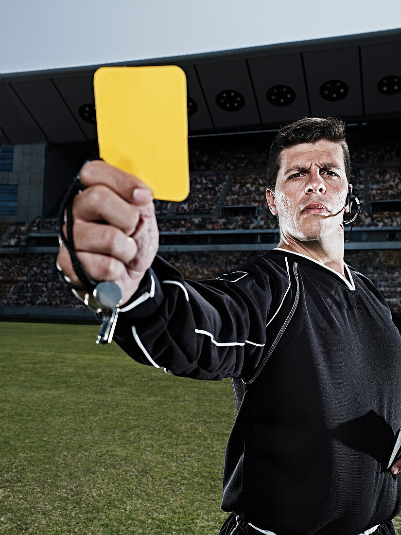 Referee flashing yellow card
