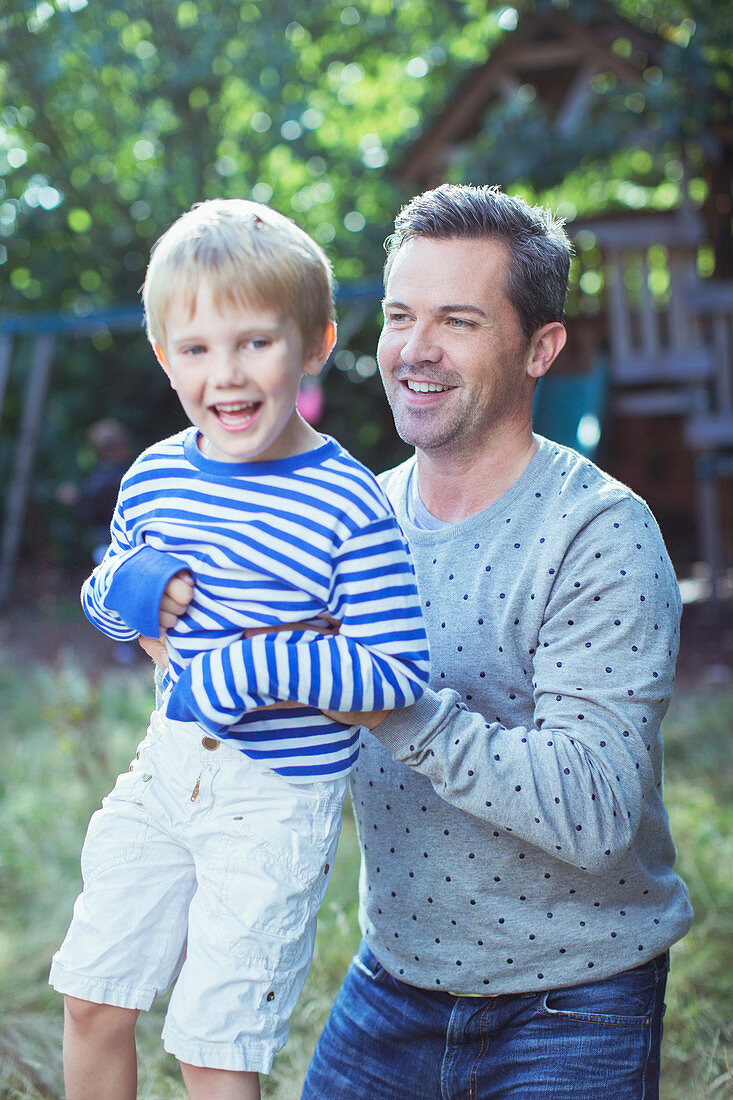 Father carrying son outdoors