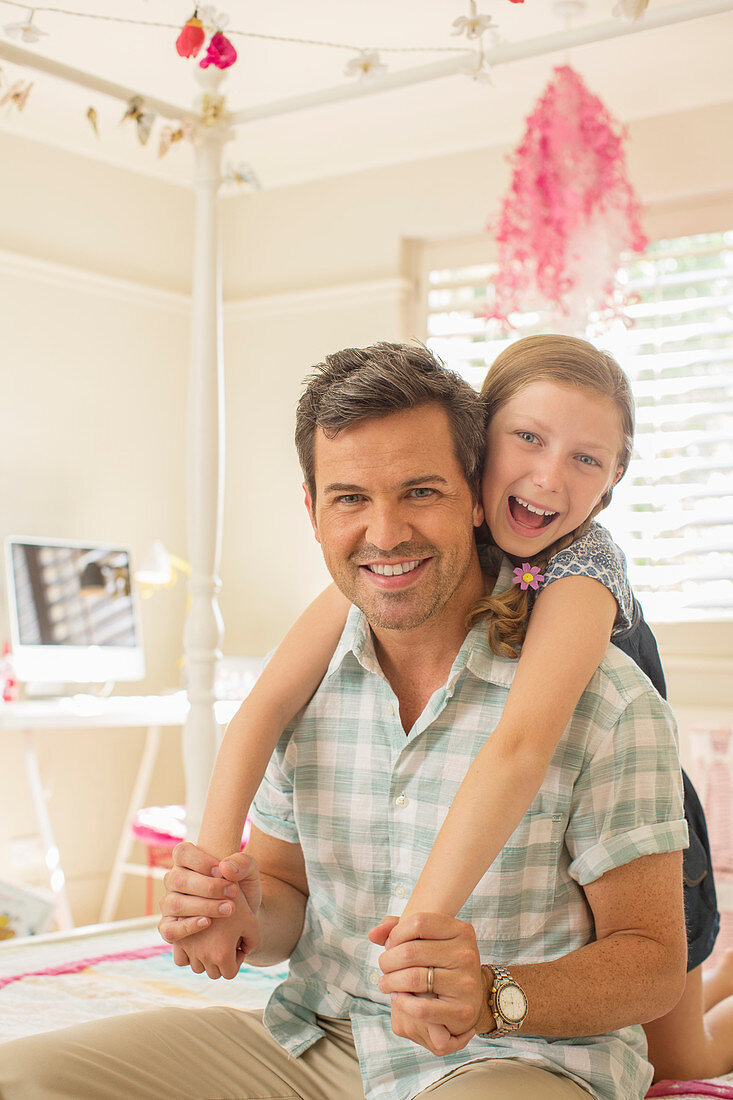 Father and daughter hugging on bed