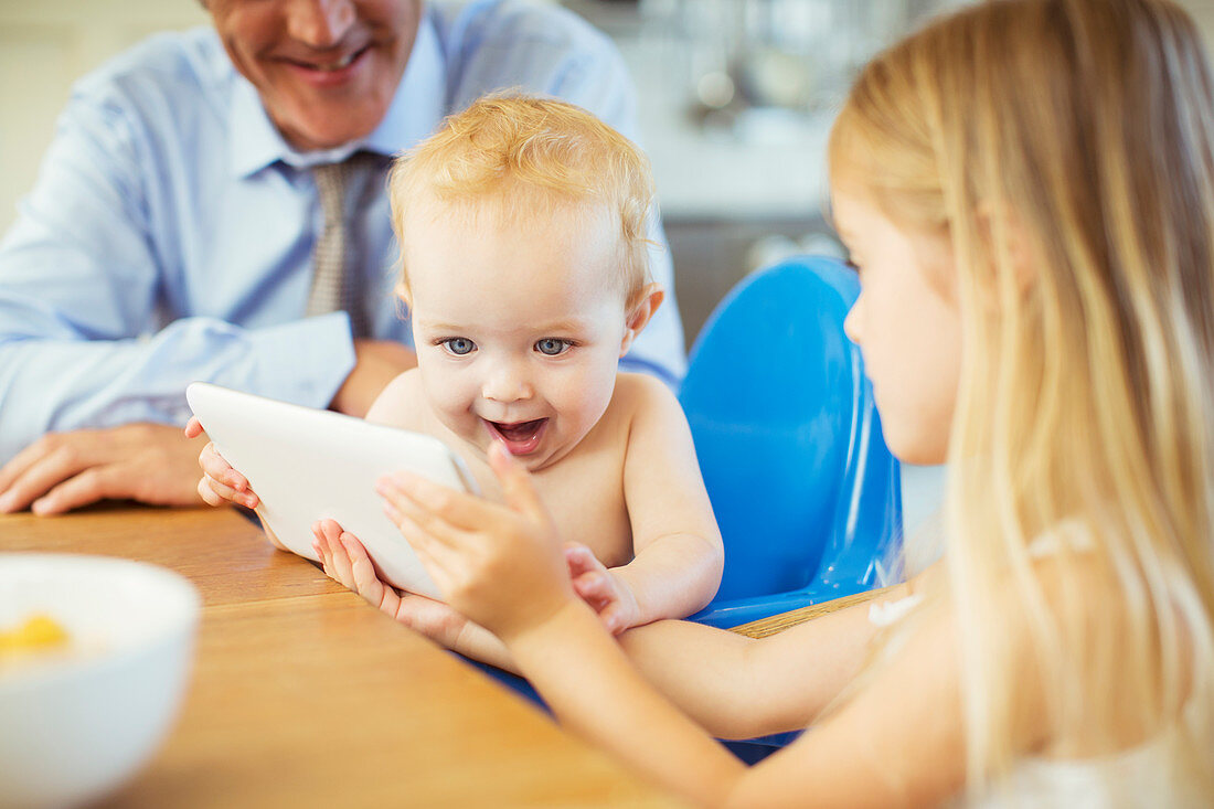 Girl showing baby digital tablet