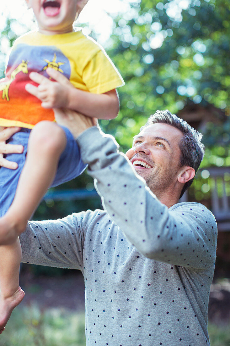 Father playing with son outdoors