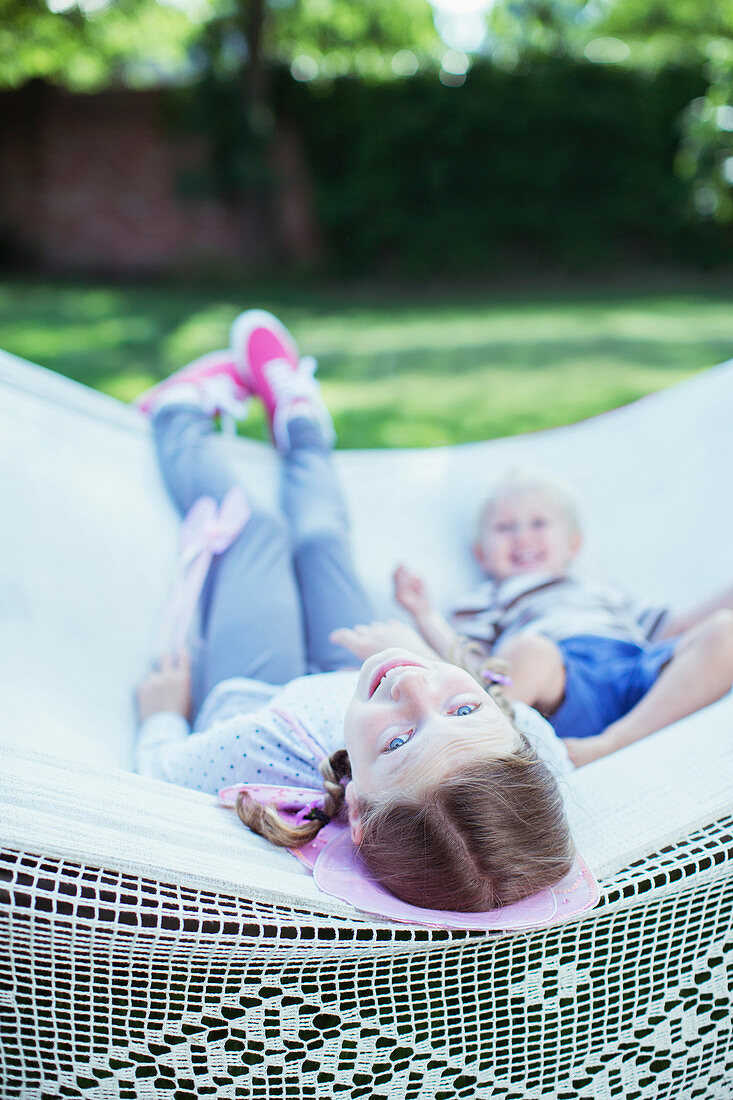 Children relaxing in hammock outdoors