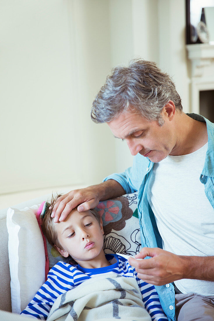 Father checking son's temperature