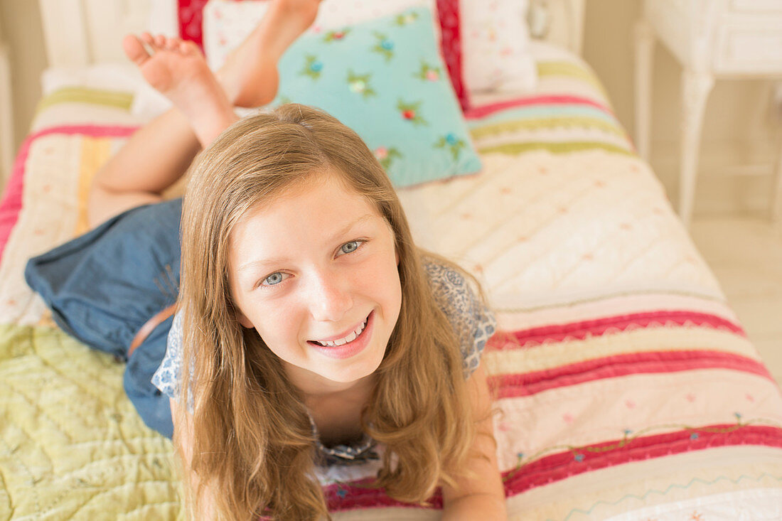 Smiling girl laying on bed