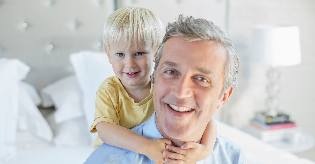 Father and son hugging on bed