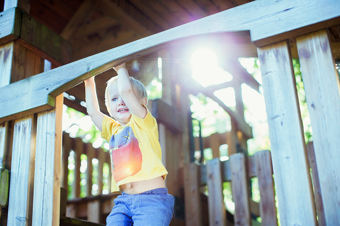 Boy playing on play structure outdoors