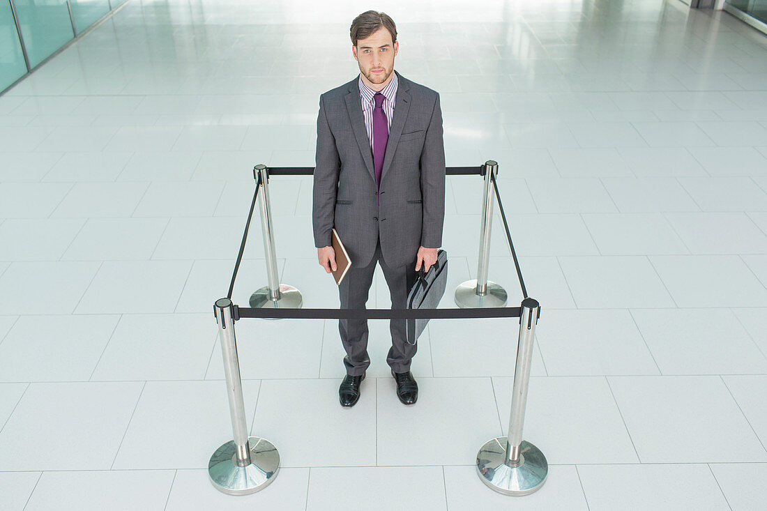 Businessman standing in roped-off square