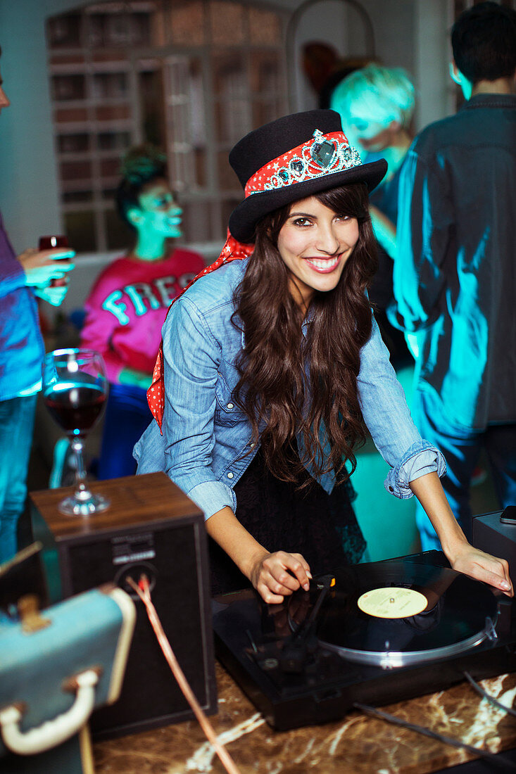 Woman playing records at party