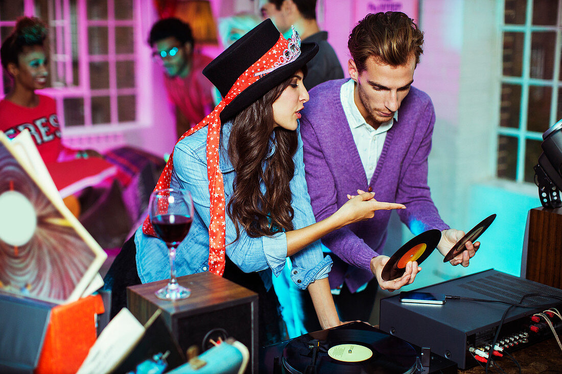 Couple playing records at party