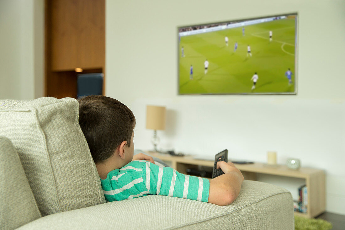 Boy watching television in living room